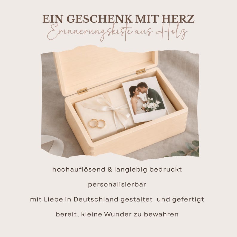 May include: A light-colored wooden keepsake box with a hinged lid, containing a wrapped gift, a photograph of a couple, and two gold rings. The box has text that reads "A gift with heart".