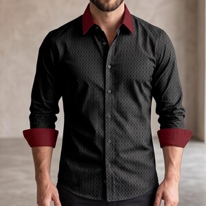 May include: A long-sleeved button-down shirt featuring a black fabric with a subtle geometric pattern. The shirt includes a contrasting deep red collar and matching deep red cuffs that are folded back. The garment has a standard front button placket.