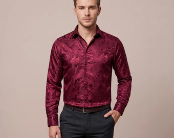 May include: A long-sleeve button-down shirt in a deep burgundy color featuring a tonal, swirling paisley-inspired jacquard pattern. The shirt has a classic collar, a front button placket, and is tucked into dark charcoal gray trousers with a belt.
