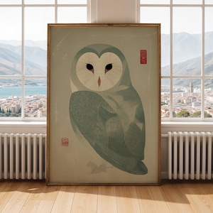 May include: Framed art print featuring a stylized owl illustration in shades of teal and cream. The owl is depicted with intricate line work, and the print includes two red stamps. The artwork is displayed in a wooden frame.