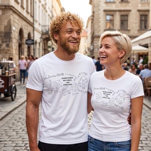 May include: Two white short-sleeved t-shirts featuring a black graphic print on the chest. The design includes various mathematical formulas, geometric shapes, and the text "WHERE OTHERS SEE CHAOS, I SEE STRUCTURE" printed in a clear, sans-serif font.