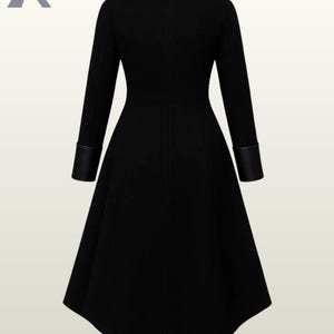 May include: A long black coat with a flared skirt, leather collar, and leather cuffs. The coat has a tailored fit and a classic design. The coat is a stylish outerwear garment.