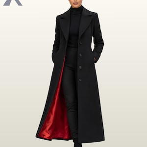 May include: A long black coat with a vibrant red lining, featuring a notched lapel, a front button closure, and long sleeves. The coat is worn over a black ribbed turtleneck sweater and black trousers, creating a sleek and structured appearance.