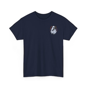 May include: A navy blue short-sleeve t-shirt featuring a small graphic on the left chest. The design depicts a white ghost draped over a black cat, surrounded by small orange and red bats and swirling lines against a dark circular background.