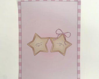 May include: A pink and white framed print featuring two star-shaped designs connected by a pink bow. Each star has text that reads "whatever happens" and "in letting it". The background is light pink.
