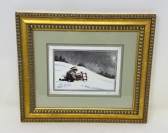 Signed and Numbered Print: Child Sledding in Winter. Nicely Framed.