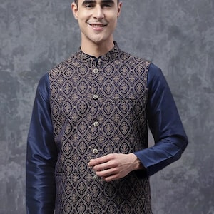May include: A navy blue vest with a gold geometric pattern over a navy blue long-sleeve shirt. The vest has a mandarin collar and button closure. The outfit is a traditional style.