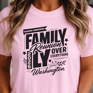 May include: A light pink t-shirt with a black graphic that reads "FAMILY Reunion OVER EVERYTHING" with the year "2026" and "Washington" below. The shirt also has the words "MAKING MEMORIES" above the word "FAMILY".