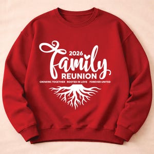 May include: A red sweatshirt with white text that reads "2026 Family Reunion." Below the text are the words "Growing Together Rooted in Love Forever United" and a white graphic of tree roots. The sweatshirt has a crew neck and long sleeves.