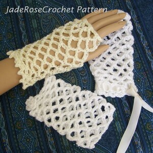 May include: Two pairs of crocheted fingerless gloves, one pair is white and the other is a pale yellow. The gloves are made with a delicate open stitch pattern.