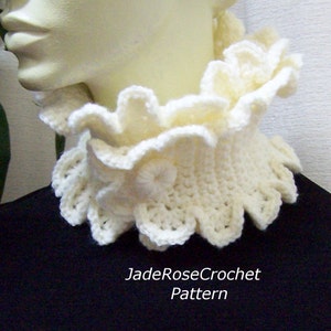 May include: A white crocheted collar with a ruffled edge. The collar is worn on a white mannequin. The text "JadeRoseCrochet Pattern" is visible below the collar.