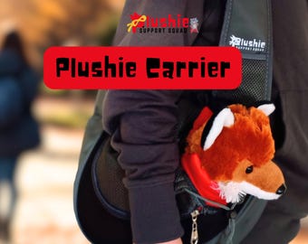 May include: A dark gray sling-style carrier bag featuring the text Plushie Support Squad and a plush fox toy tucked inside. The bag has a mesh panel, a zipper closure, and a drawstring cord. The fox has orange and white fur with black ears.