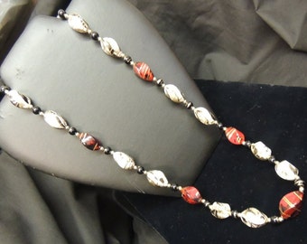 Vintage 1970's women's single strand red white and black beaded necklace with gold accents