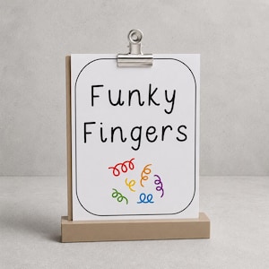 May include: A white rectangular sign with rounded corners held by a silver metal clip on a tan wooden base. The sign features the black text Funky Fingers and a collection of small, colourful, curly line graphics in red, orange, yellow, green, blue, and purple.