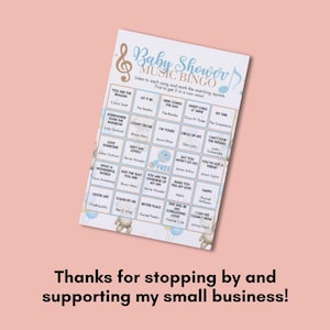 May include: A baby shower music bingo game card with a light blue and gold musical note design. The card features song titles and artist names, with a teddy bear graphic at the bottom. The text reads "Baby Shower Music Bingo".