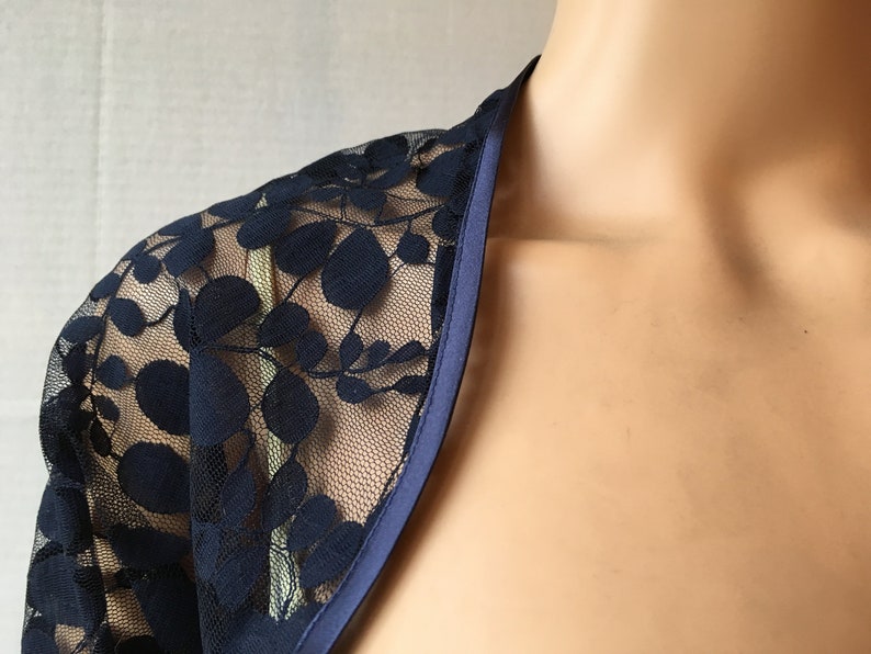Dark bluenavy leaf design lace elbow length sleeved boleroshrugjacket with satin edging