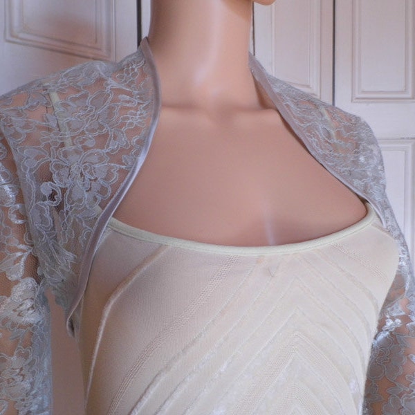 Silver lace three-quarter length sleeved bolero/shrug/jacket  with satin edging