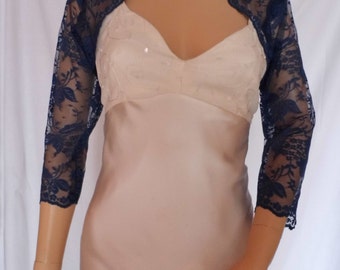 Dark blue  lace three-quarter length sleeved bolero/shrug/jacket  with scalloped edging.  UK sizes 8, 10, 12, 14, 16