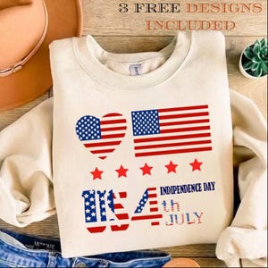 Peut inclure: Un sweat-shirt à col rond couleur crème avec un motif rouge, blanc et bleu représentant un drapeau américain en forme de cœur, un drapeau rectangulaire, cinq étoiles et le texte 3 FREE DESIGNS INCLUDED, USA, INDIPENDENCE DAY, 4TH JULY.