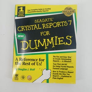 May include: A paperback book titled Seagate Crystal Reports 7 For Dummies by Douglas J. Wolf. The cover is yellow and black with white and yellow text, featuring a cartoon hand graphic and the IDG Books logo in the bottom left corner.