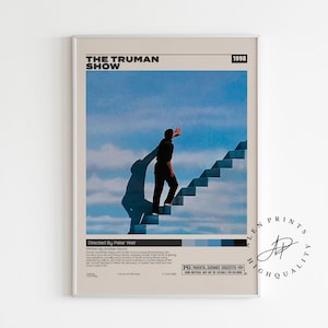 May include: Framed poster for "The Truman Show" film. A man is seen climbing stairs against a blue sky backdrop. The poster includes the film's title, year, and credits, along with a PG rating.
