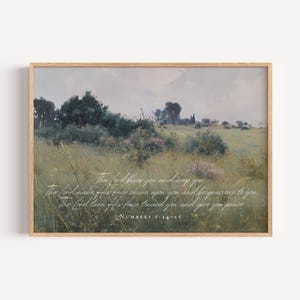 May include: A framed landscape print featuring a field of tall grass and trees under a cloudy sky. The artwork has a vintage aesthetic with soft colors. Scripted text from Numbers 6:24-26 is overlaid on the image.