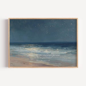 Pode incluir: Uma pintura de paisagem emoldurada retrata uma serena paisagem marinha sob um céu noturno estrelado. A obra apresenta uma praia arenosa, ondas do oceano e um céu azul escuro. O texto na parte inferior diz "Salmo 107:29".
