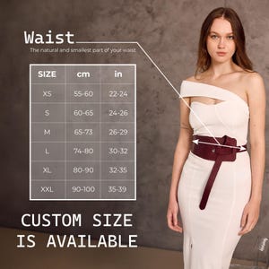 May include: A burgundy leather waist belt with a unique wrap design, worn over a white dress. The image includes a size chart with measurements in inches and centimeters, and text that reads "CUSTOM SIZE IS AVAILABLE."