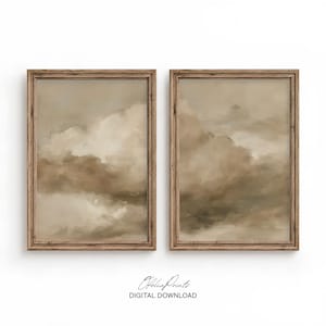 May include: Two vertical rectangular wall art prints in wooden frames, each featuring an abstract oil painting of soft, layered clouds in shades of beige, taupe, and cream. The text Ofelia Prints DIGITAL DOWNLOAD is centred below the frames.