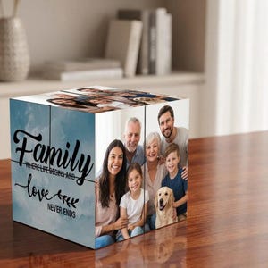 May include: A square photo block featuring a light blue sky background with the black text Family where life begins and love never ends. The adjacent side displays a color photograph of a family of four and a golden retriever dog.