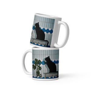 Mug with a painting of a black cat and plant, background with a blue and white pattern, tiles, artwork on everyday objects, P. Trindade