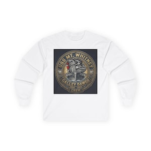 May include: A white long-sleeve shirt featuring a circular graphic on the chest. The design depicts a bulldog wearing sunglasses atop a ship, surrounded by text reading USS MT. WHITNEY GALLEY DAWGS 1990-1993 CREW in a metallic gold and grey tone.