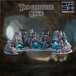 May include: A miniature gray cave diorama with the text "Troglodyte Cave". The cave features rock formations and glowing blue crystals. The diorama is designed for tabletop gaming or display.