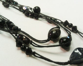 3 Strand Black and Grey Glass and Plastic Bead with rope Necklace
