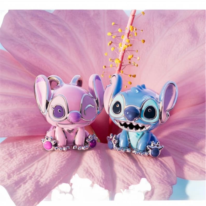 May include: Two character figurines, one pink and one blue, are set against a pink flower backdrop. The pink figurine winks, while the blue one smiles, both with metallic accents. These collectible figures are inspired by a popular animated film.