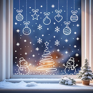 May include: A window scene with white Christmas decorations against a blue background. The design includes hanging ornaments, snowflakes, a Christmas tree, and snowmen. A small potted evergreen tree sits on the windowsill.