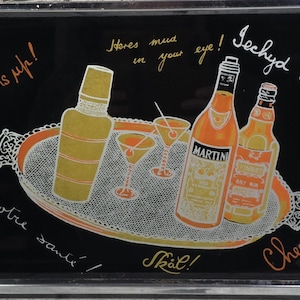 May include: A black serving tray with a silver frame and handles. The tray features a cocktail-themed design with a shaker, martini glasses, and bottles of liquor. Text includes phrases like "Bottoms up!" and "Cheers!"