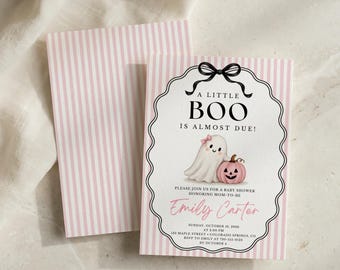 May include: A baby shower invitation card and matching envelope featuring a pink and white vertical striped pattern. The card displays a black bow, a ghost with a pink bow, and a pink pumpkin. Text reads A LITTLE BOO IS ALMOST DUE, Emily Carter, and event details.