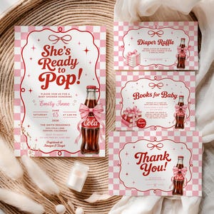 May include: A baby shower invitation set featuring a pink and white checkered pattern, red text, and a glass soda bottle illustration with a pink bow. The cards include text for a diaper raffle, books for baby, and a thank you note with event details.