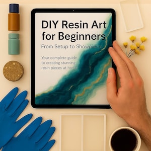 May include: An overhead shot features a tablet displaying "DIY Resin Art for Beginners." The image includes resin art supplies, blue gloves, and a cup of coffee. The text reads "Create beautiful resin art - no experience needed."