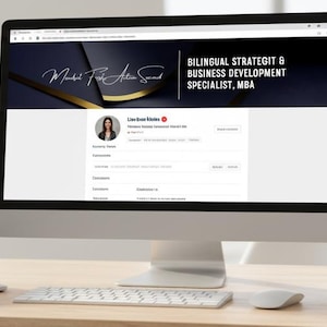 May include: A modern office setup featuring a laptop and a large desktop monitor displaying a website. The monitor shows the text "Bilingual Strategy & Business Development Specialist, MBA". A small potted plant and a notebook are also on the desk.