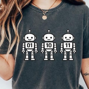 Peut inclure: Ensemble de trois tasses en céramique avec une finition mate et mouchetée. Les tasses sont dans des tons crème, gris clair et gris foncé. Chaque tasse a un design simple et minimaliste, parfait pour le café ou le thé.