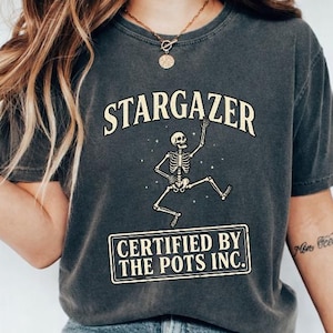 May include: A white ceramic mug with a black handle and the text "But First, Coffee" in a handwritten style. The mug is on a white surface. The mug is approximately 4 inches tall.