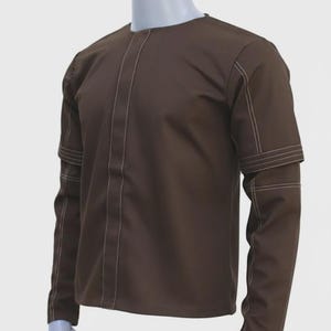 May include: A brown long-sleeved shirt with white stitching details. The shirt has a round neckline and decorative stitching down the front and on the sleeves. The sleeves have a unique design with horizontal stitching.