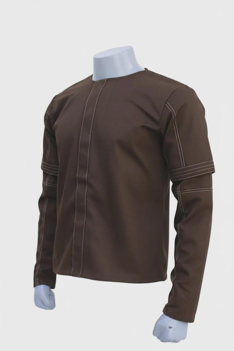 May include: A brown long-sleeved shirt with white stitching details. The shirt has a round neckline and decorative stitching down the front and on the sleeves. The sleeves have a unique design with horizontal stitching.