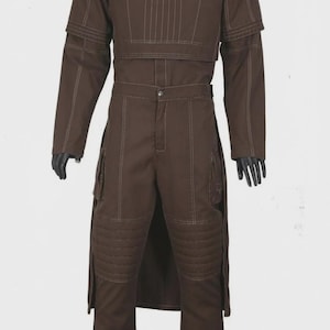 May include: Brown two-piece outfit with white stitching. The top has a crew neck and a layered design. The pants have cargo pockets and quilted knee pads. The outfit is a solid brown color.
