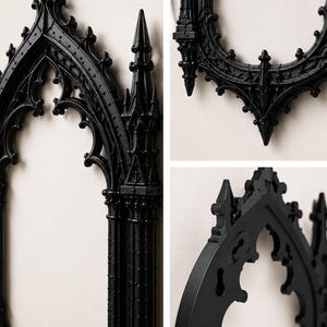 May include: A black wall-mounted mirror frame featuring intricate architectural details inspired by gothic cathedral arches, including pointed spires, slender columns, and ornate tracery patterns along the vertical and curved edges.