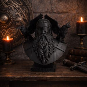 May include: A black bust of a bearded man with a blindfold, flanked by two ravens. The bust is on a wooden surface, with lit candles and a shield in the background. The text "KOSMIUM CULT" is at the base.