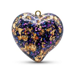May include: A heart-shaped pendant with a gold-colored loop at the top. The pendant is a deep blue color with gold leaf and colorful glitter embedded within. The heart is a solid, smooth shape.