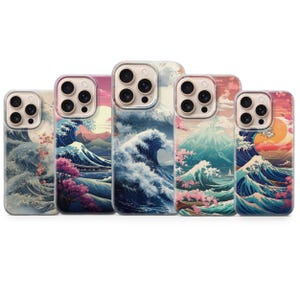 May include: Five phone cases with a Japanese-inspired design. Each case features a different landscape with ocean waves, mountains, and cherry blossoms in shades of blue, pink, and orange. The cases have clear edges.